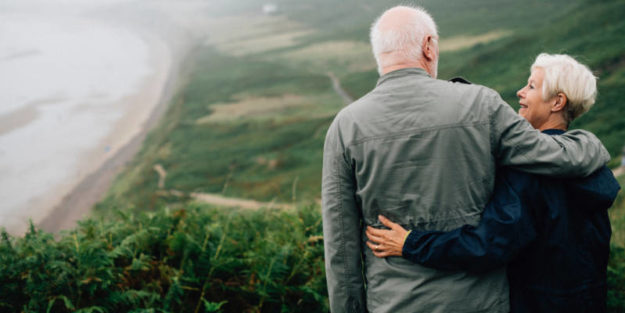 New Grandparent Couple Looking at Each Other on the Coast, Corona Estate Planning Attorney.