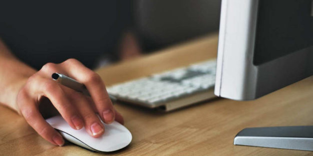 Person Behind a Computer With Hand on the Mouse, Corona Estate Planning Attorney.