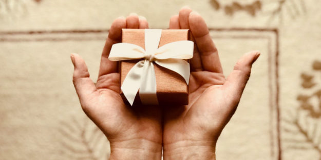 Two Hands Holding a Gift with Hudack Law Corona Estate Planning Attorney.
