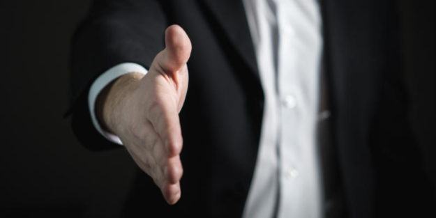 A Business Owner Showing His Hand for a Handshake With Corona Estate Planning Attorney.