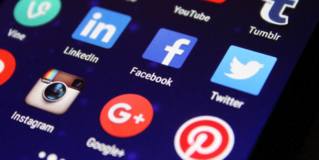 Social Icons on a Digital Device, Money and Pencils Piling on a Sheet of Paper After Tax Reform Conversions, Corona Estate Planning Attorney.