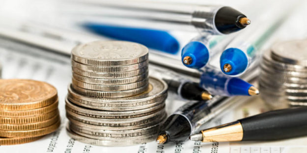 Money and Pencils Piling on a Sheet of Paper After Tax Reform Conversions, Corona Estate Planning Attorney.