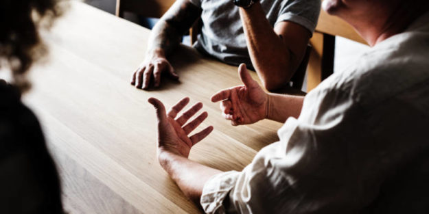 An Elderly Man Having Conversation With Son and Daughter on a Table, Corona Estate Planning Attorney.