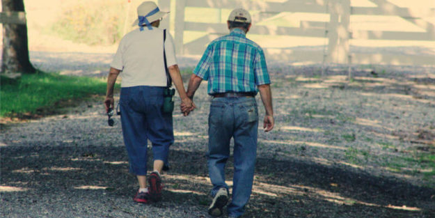 An Elderly Couple Walking Holding Hands, Corona Estate Planning Attorney.