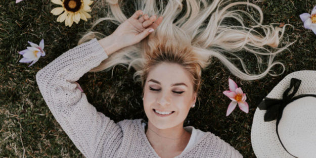 A Woman Lying Down on the Grass Dreaming Her Estate Planning With a Smile at Corona Estate Planning Attorney.