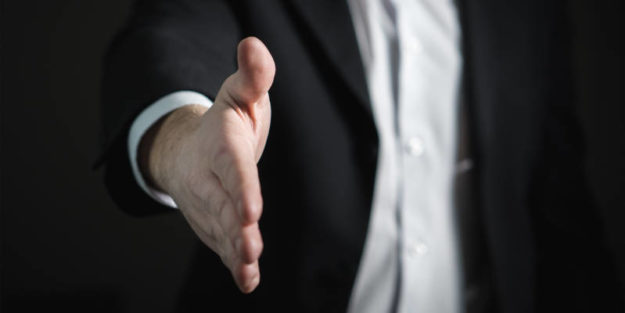 A Business Owner Showing His Hand for a Handshake with an Estate Planning Attorney.