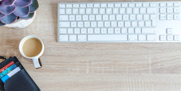 White Apple Keyboard and Cup of Coffee on a Wooden Table, Estate Planning Attorney.