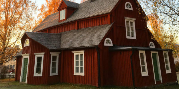 Red House With White Windows and a Grey Roof Surrounded by Trees, Estate Planning Attorney.
