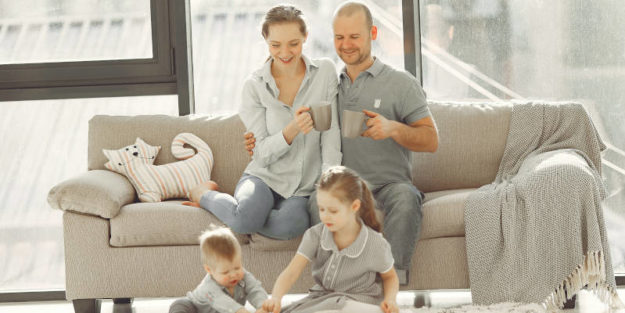 A Happy Family Having Fun at Home on a Grey Couch, Estate Planning Attorney.