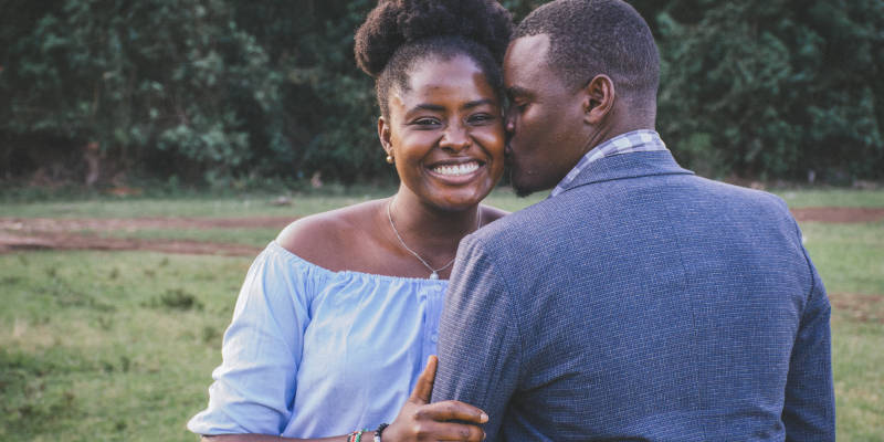 A Man Kissing Left Cheek of Smiling Woman, Corona Estate Planning Attorney.