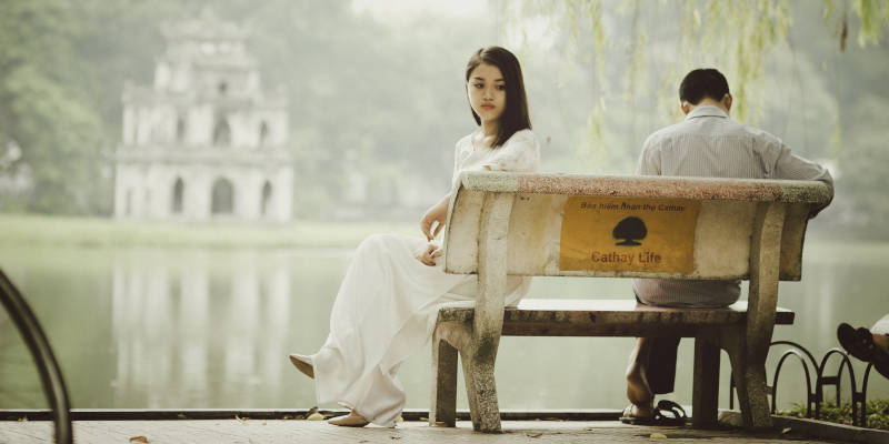 An Asian Couple Sitting on a Bench at the Lake, Corona Estate Planning Attorney.