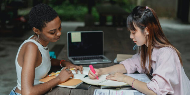 Two Female Students Forming an Llc Plan on a Table, Corona Estate Planning Attorney.