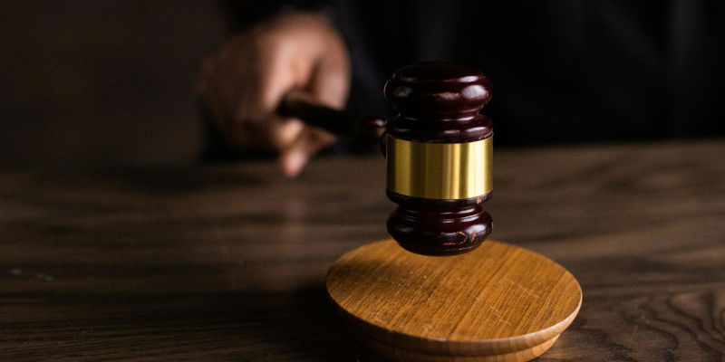 Hand holding a gavel, symbolizing legal authority and control in Estate 2024 Planning amidst potential tax changes.